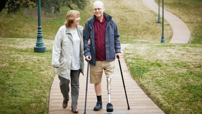 Alan walking with Kenevo and crutches