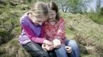 girls playing with salamander while one uses her electric hand 2000